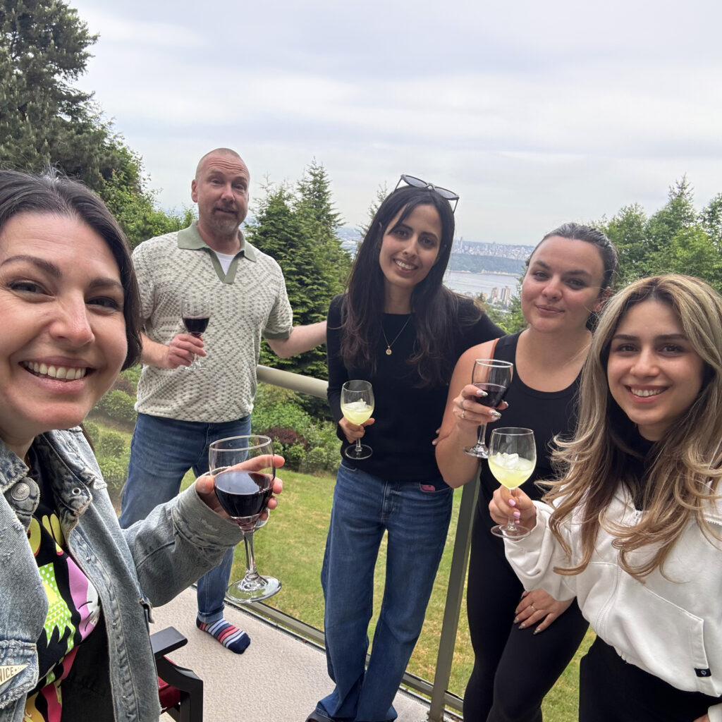 The team on the balcony with drinks.