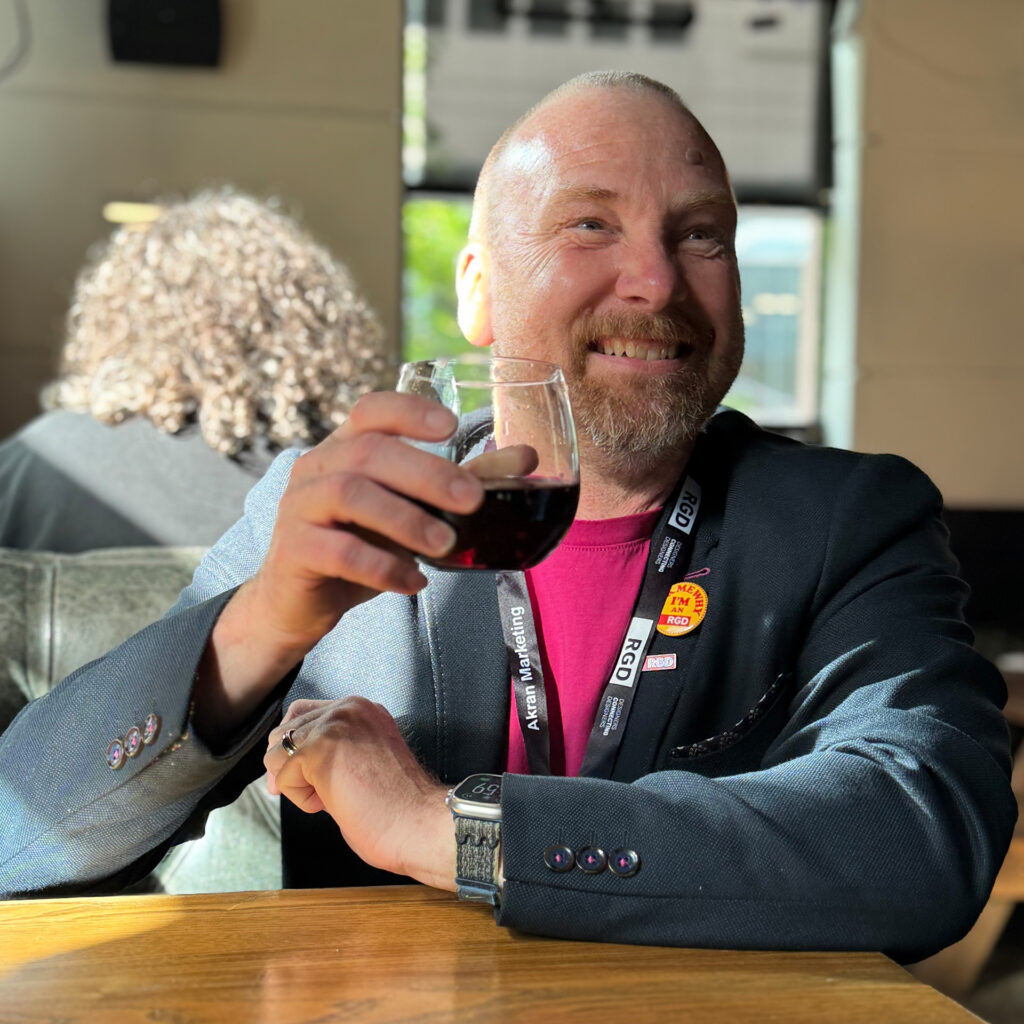 Brent holding a glass of wine
