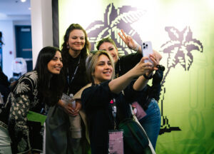 Team fusion taking a selfie in front of DesignThinkers backdrop